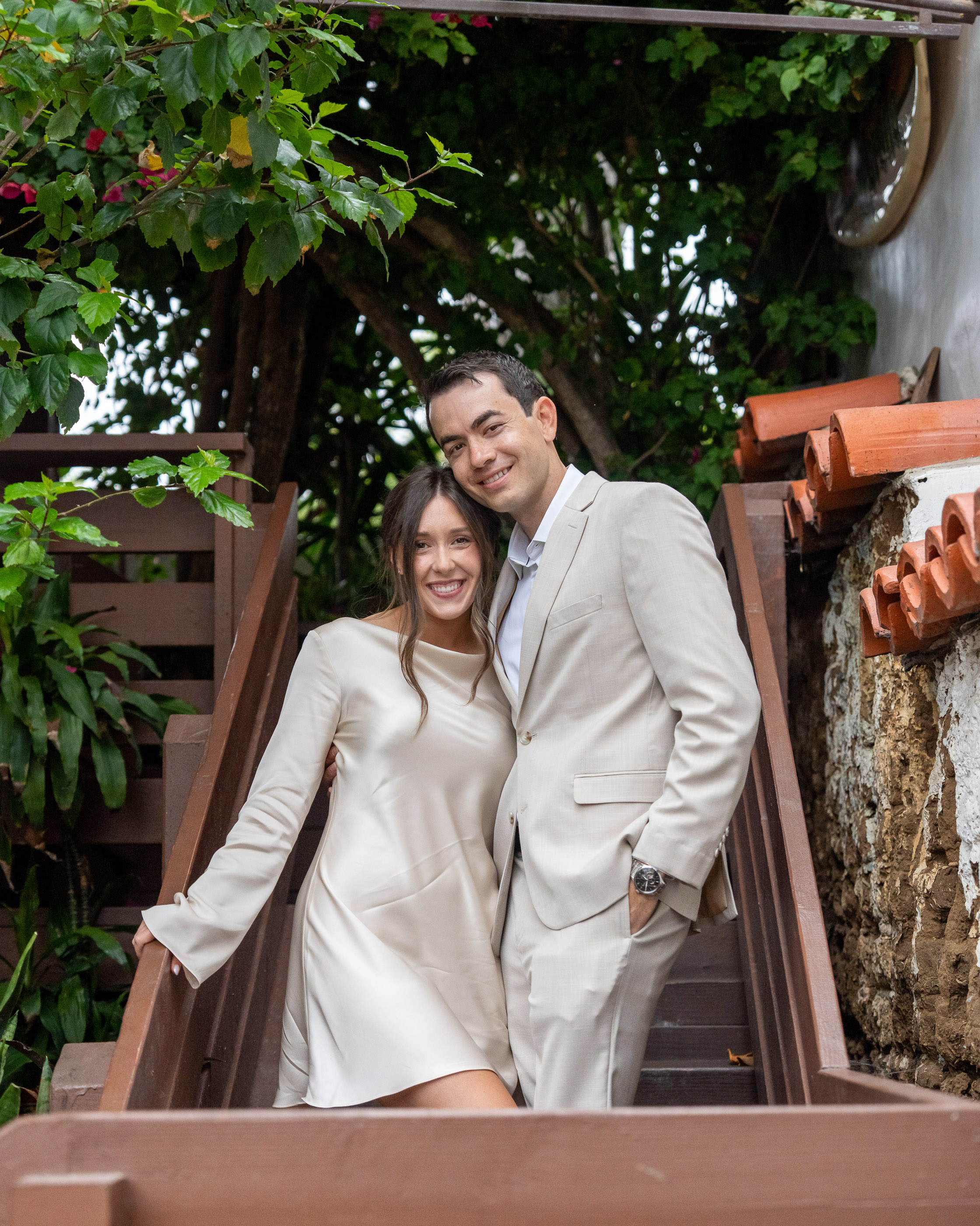 Couple sitting together and smiling on a shaded outdoor patio