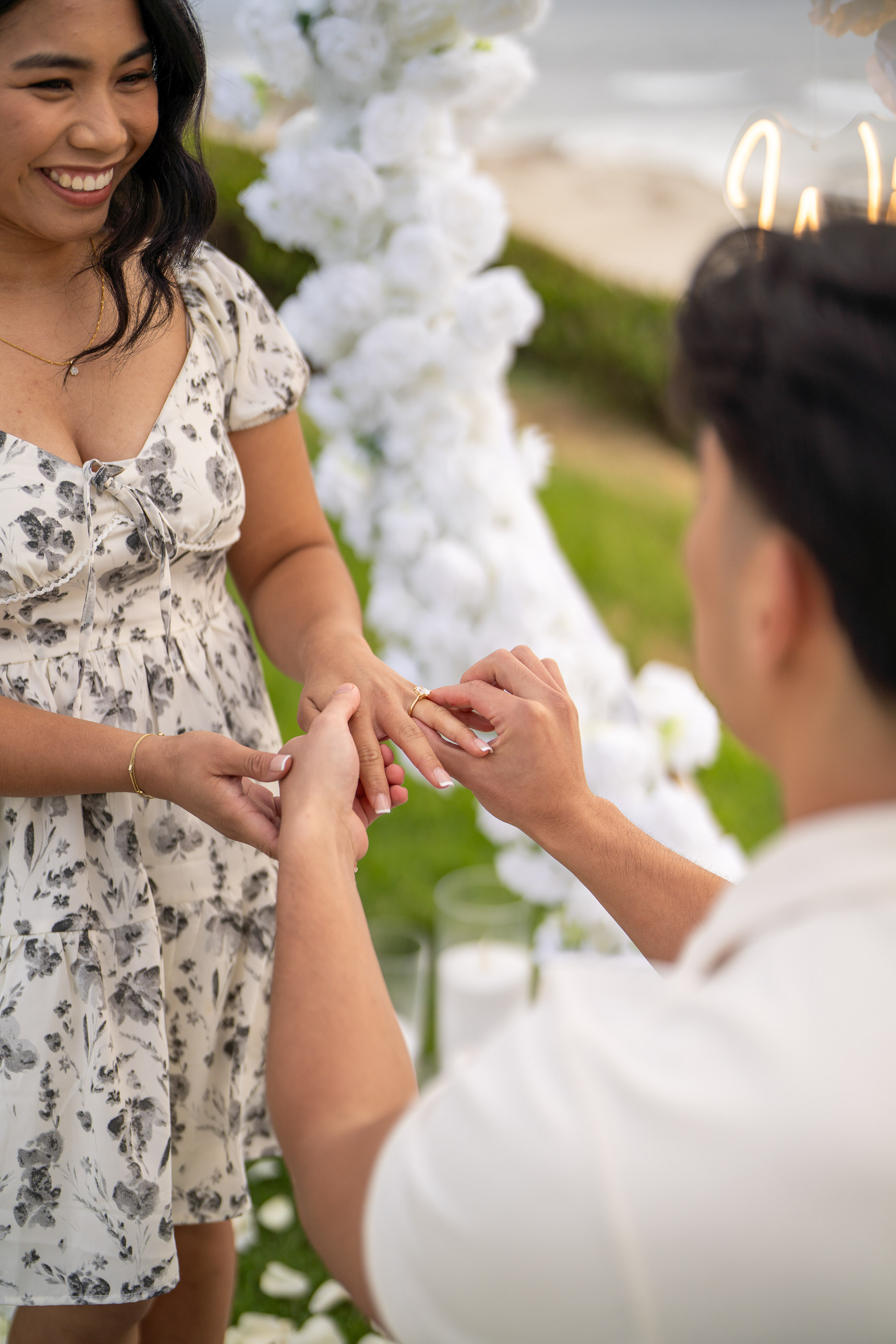 Close-up of a couple exchanging rings during an engagement proposal